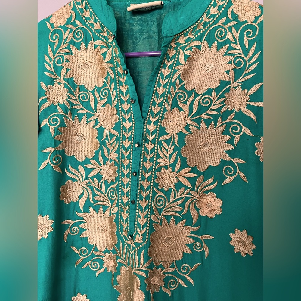 Beautiful green salwar with a lot of embroidery work in the front and back